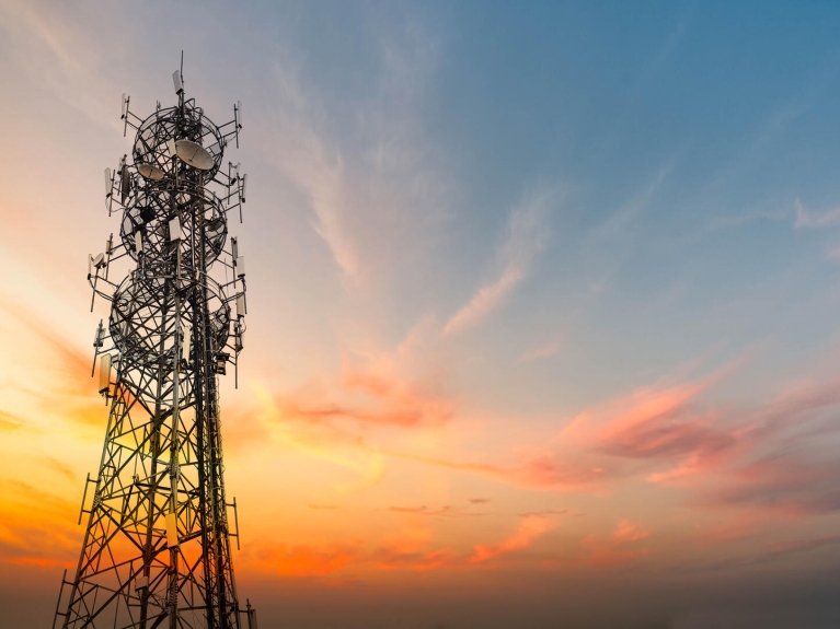 5G Sunset Cell Tower Cellular communications tower for mobile phone and video data transmission