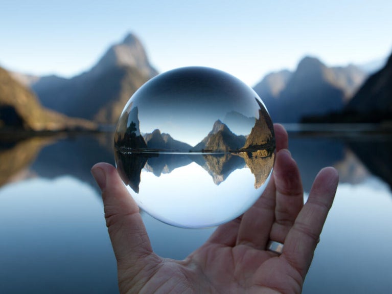 Hand holding glass ball