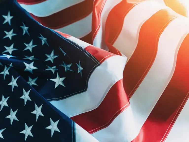 American Flag or United States of America national flag background in sunlight, close up.