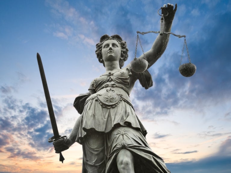 metal justice statue with sky in background in Frankfurt am Main, Germany