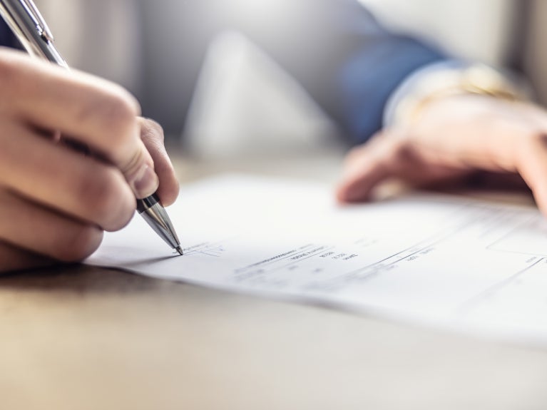 Person signing a paper