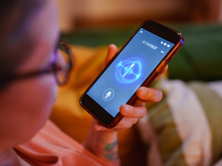 Woman speaking to AI chatbot on smartphone