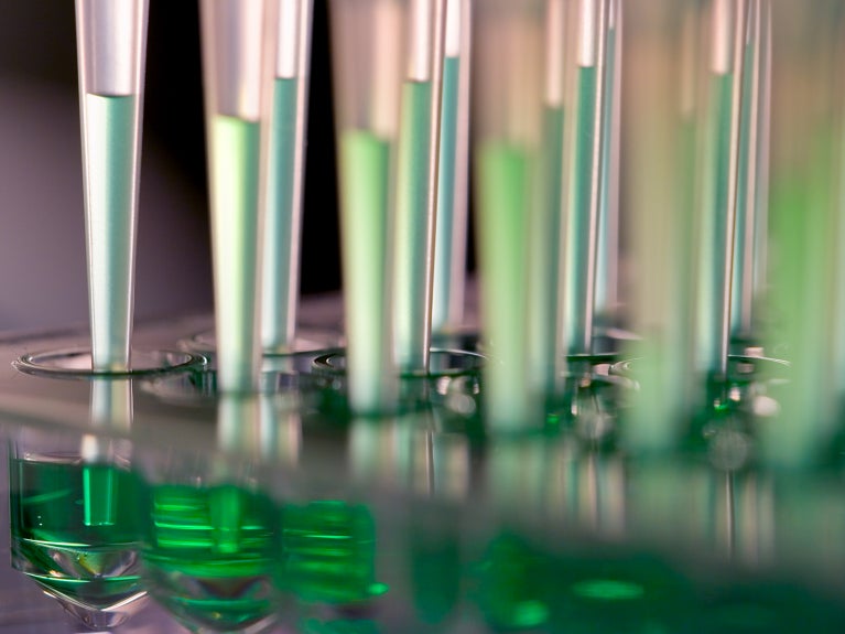 Vials of liquid and pipettes in a lab
