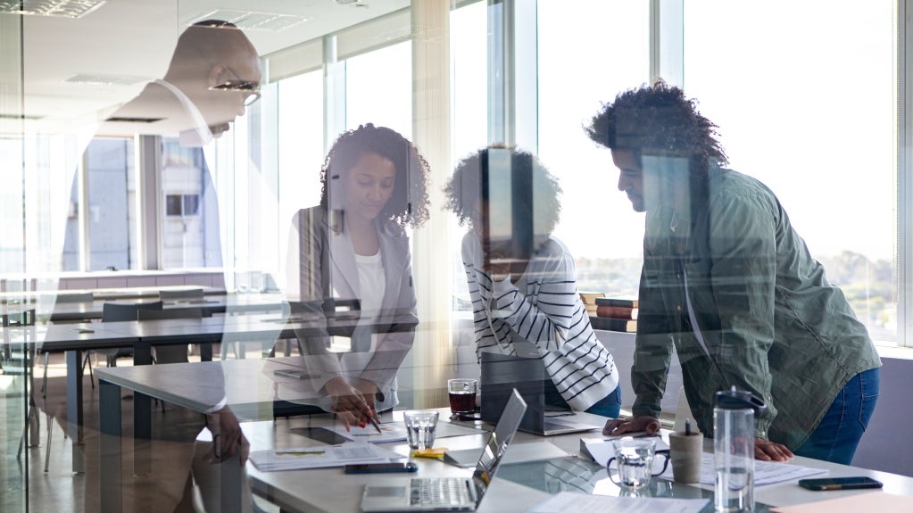 people gathered around a workspace