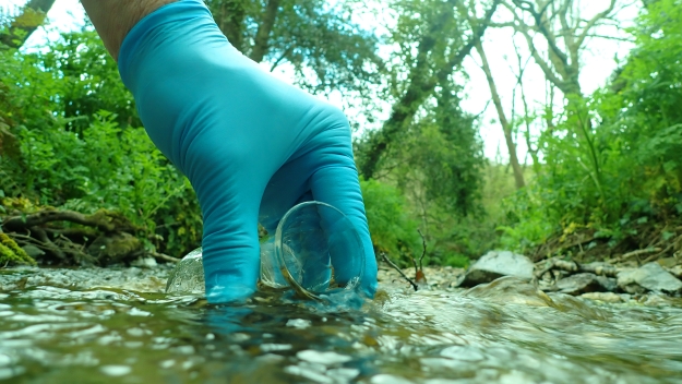 collecting a water sample from a stream