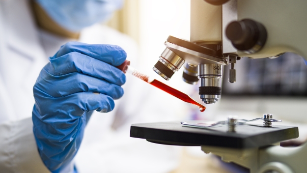 Healthcare image, doctor putting liquid under a microscope 