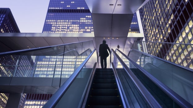 person going up escalator 